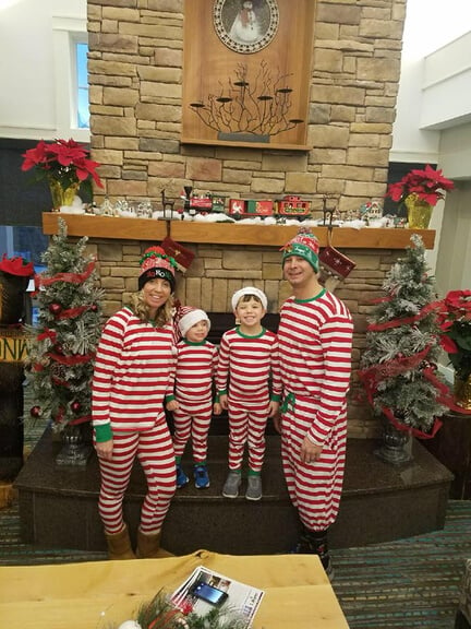 A photo of a family in the lobby of the Residence Inn wearing their holiday pajamas