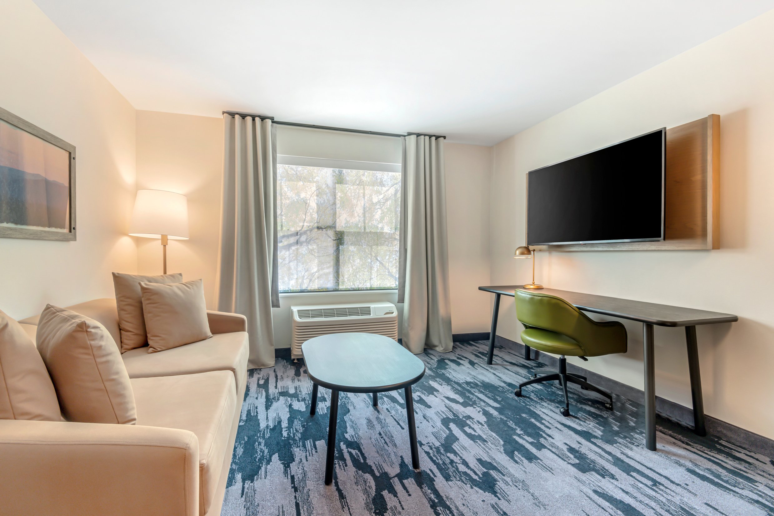 A photo of a living area in a suite at the Fairfield Inn